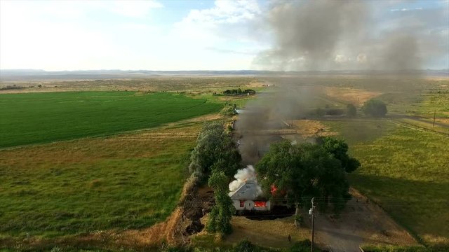 Aerial footage of house burning down