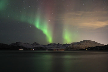 Northern lights reflected in seawater. Tromso, Norway.