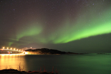 Northern lights reflected in seawater. Tromso, Norway.