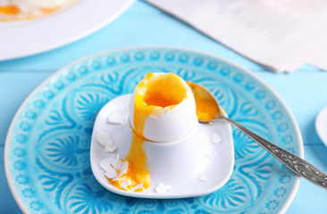 Holder with soft boiled egg on table