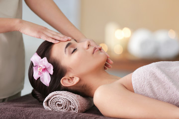 Young woman having face treatment in spa salon