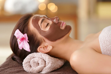 Obraz na płótnie Canvas Young woman having face treatment in spa salon