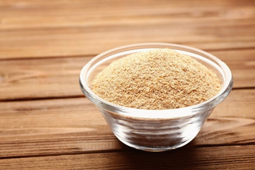 Glass bowl of breadcrumbs on wooden table