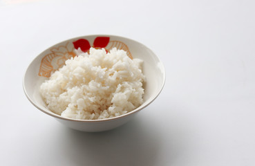 Rice cooked in bowl on white background