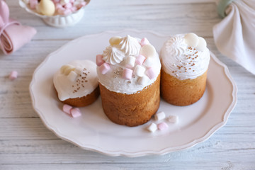 Beautiful plate with traditional Russian Easter cakes on wooden table