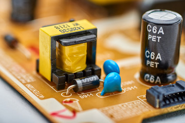 Resistors, capacitors and other electronic components of micro chip inside the computer close up