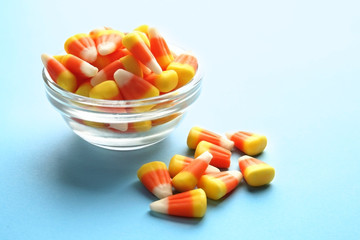 Colorful Halloween candy corns on blue background