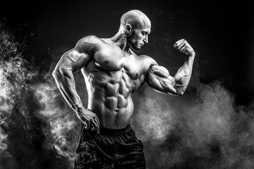 Strong bald bodybuilder with six pack. Bodybuilder man with perfect abs, shoulders,biceps, triceps...