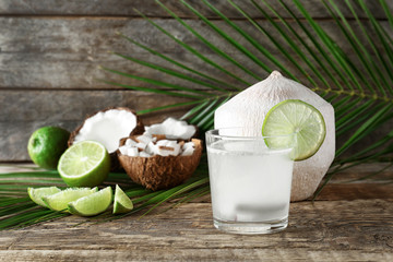 Composition with fresh coconut milk on wooden table © Africa Studio