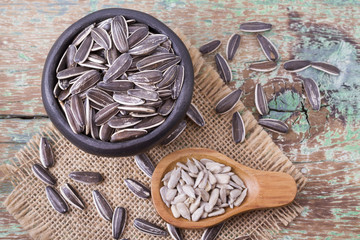 pile of sunflower seeds on wooden background
