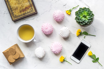 home office with flowers spring concept on marble background top view