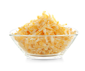 Glass bowl with grated cheese on white background