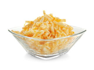 Glass bowl with grated cheese on white background