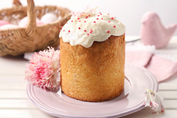 Plate with delicious Easter cake on table