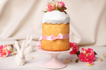 Fototapeta na wymiar Easter cake decorated with flowers on ceramic stand