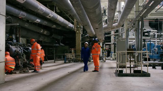  Portrait of smiling Asian engineer at work in industrial plant