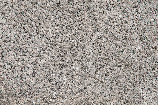 Closeup of grey granite texture as a wallpaper concept for designers background applying