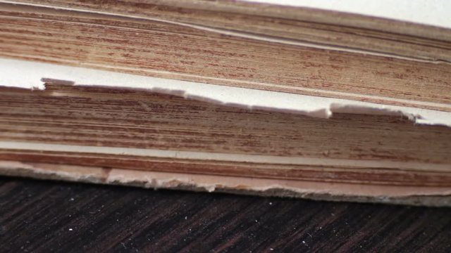 Turning the pages of an old book close-up