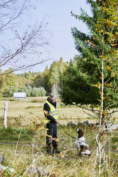 Sweden, Uppland, Rison, Volunteer with dog helping emergency services find missing people