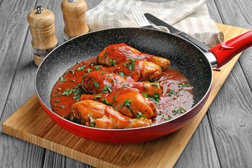 Frying pan with chicken cacciatore on kitchen table