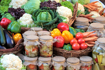 Fresh colorful vegetables and pickles in jars