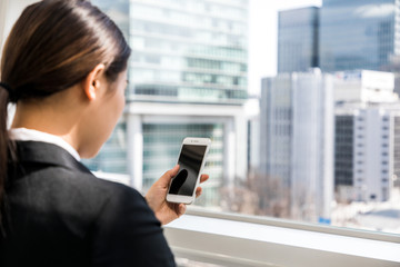 businesswoman looking smart phone screen