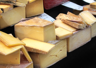 Various cheese on a market stand