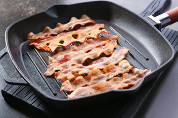 Tasty bacon slices on grill pan