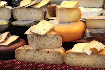 Various cheese on a market stand