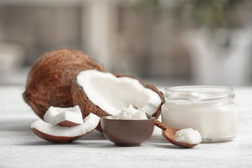 Fresh coconut oil and nuts on wooden table