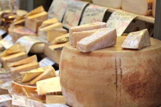 Parmesan cheese and various cheese on a market stand