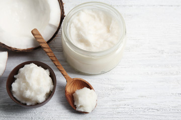 Composition with fresh coconut oil on wooden background