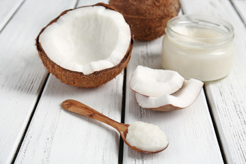 Composition with fresh coconut oil on wooden background