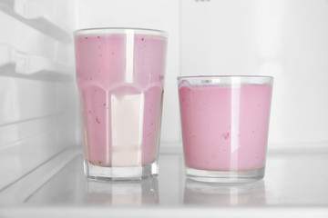 Two glasses of yogurt standing in fridge