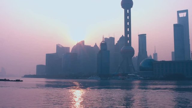 TIMELAPSE sunrise morning shot of Shanghai skyline central business district over Huangpu river. 4K UHD 