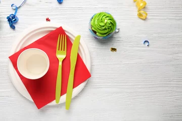 Fototapeten Plate with birthday cupcake and cup on wooden table © Africa Studio