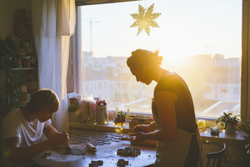 Finland, Helsinki, Couple preparing christmas cookies