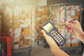 Worker Scanning Package In Warehouse