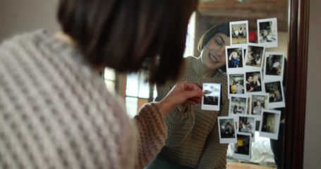 Young adult female looking at photos of friends - Powered by Adobe