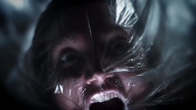 4K Horror Shot Of Woman Suffocating in Plastic Bag