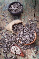 pile of sunflower seeds on wooden background