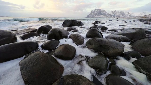 Movement of water on the shores of cold Norwegian Sea at evening time. Lofoten islands. Beautiful Norway landscape. Slow Motion HD Footage.