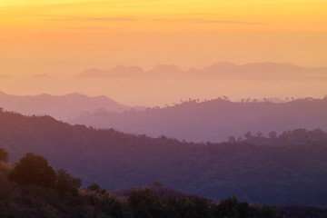 Fototapeta na wymiar high view sunrise in early morning over rainforest mountain in thailand 