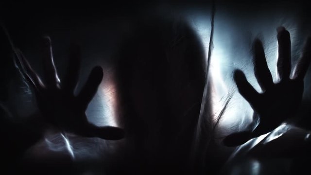 4K Horror Shot Of Hands Silhouette on Plastic Curtain