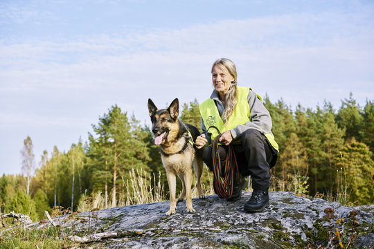 Sweden, Uppland, Rison, Portrait of volunteer with dog helping emergency services find missing people