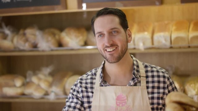  Customer in a bakery shop making contactless payment by cell phone