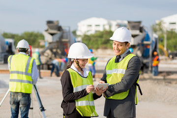 Asian businessman,Asian secretary and Asian construction engineer checking construction site for new Infrastructure construction project