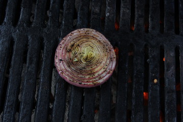 Grilled onion on a charcoal BBQ