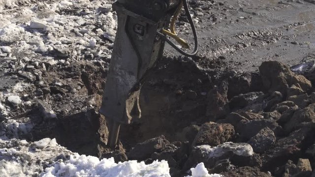 Breaker (hydraulic) cuts frozen soil stock footage video