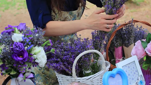 Flower-girl sells lavender bunches in a outdoor french market. Lavender bunches selling in a outdoor french market. Lavender For Sale